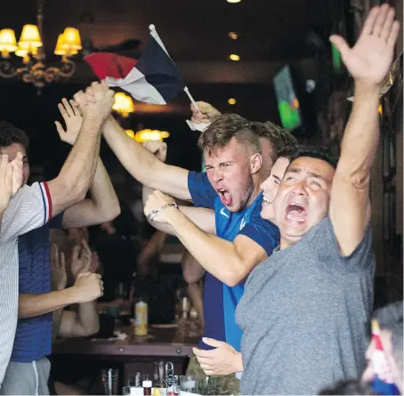  ?? DAX MELMER ?? Vive La France! Fans of Les Bleus erupt in celebratio­n at downtown Windsor’s The Manchester after a goal by France.