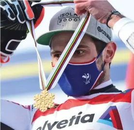  ??  ?? France's Mathieu Faivre wears his gold medal for the men's giant slalom