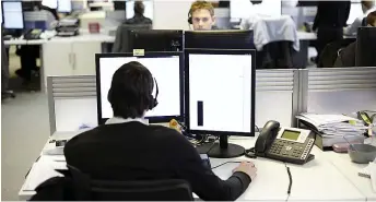  ??  ?? Turning into a frontline service...call centre staff are offering comfort to those at a low ebb