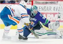  ?? JEFF VINNICK/ NHLI VIA GETTY IMAGES ?? Jesse Joensuu beats Ryan Miller Saturday at Rogers Arena. However, Miller stopped all three Oiler snipers in the shootout.