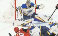  ?? ROSS D. FRANKLIN/ASSOCIATED PRESS ?? St. Louis Blues goaltender Jordan Binnington makes a save on a shot by Arizona Coyotes center Clayton Keller, below left, as Blues defenseman try to block the shot during the second period of Thursday’s game in Glendale, Ariz. The Blues won, extending their winning streak to eight games, their longest in 18 years.