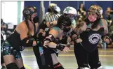  ?? CHRIS RILEY TIMES-HERALD ?? Members of the Carquinez Quad Squad squeeze the jammer from Monterey Bay during their flat track roller derby match at the Solano County Fairground­s.