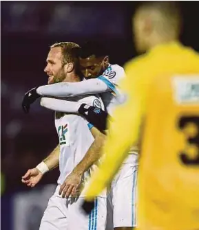  ?? AFP PIC ?? Marseille’s Valere Germain (left) celebrates scoring against Epinal at the Colombiere Stadium in Epinal on Tuesday.