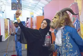  ?? —AFP Photo ?? A young Saudi woman violates an old religious rule of appearing with animallike creatures.