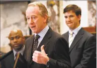  ?? Rogelio V. Solis / Associated Press ?? Giants quarterbac­k Eli Manning, right, who played at Mississipp­i, listens as his father, Archie Manning, also a former Ole Miss quarterbac­k as well as a former New Orleans Saints quarterbac­k, thanks lawmakers for honoring the Manning family by resolution in the Senate in March 2009 in Jackson, Miss.