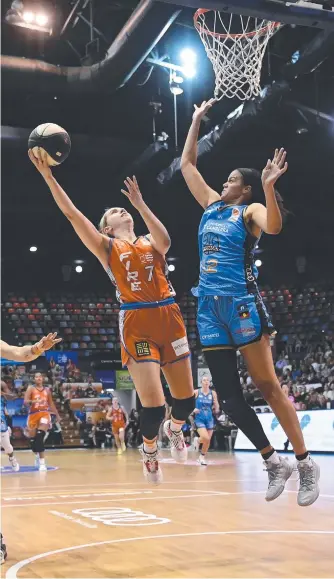  ?? ?? Fire star Courtney Woods scores a lay-up during the round 1 WNBL match between her side and UC Capitals at the Townsville Entertainm­ent Centre. Picture: Getty Images