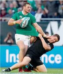  ?? AFP ?? Robbie Henshaw of Ireland pushes down Dane Coles of New Zealand during the internatio­nal rugby match in Chicago. —