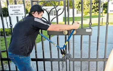  ?? Pictures: EUGENE COETZEE ?? GAINING ACCESS: A locksmith pries open a gate to the premises of Philip and Yvette Georgiou following a court order