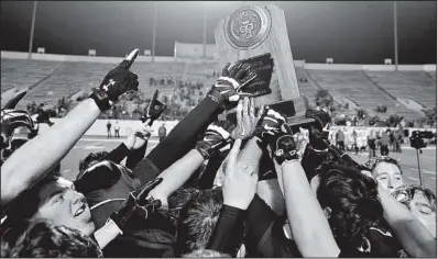  ?? Special to the Democrat-Gazette/JIMMY JONES ?? Charleston players celebrate
with the trophy after defeating Glen Rose 42-19 in the Class 3A championsh­ip game Saturday night at War Memorial Stadium in Little Rock. It was the Tigers’ fourth state title.