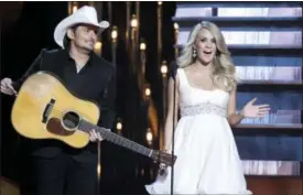  ?? PHOTO BYWADE PAYNE — INVISION — AP, FILE ?? In this file photo, hosts Brad Paisley, left, and Carrie Underwood appear at the 48th annual CMA Awards in Nashville, Tenn. Paisley and Underwood are celebratin­g their 10-year anniversar­y as hosts of the Country Music Associatio­n Awards. The duo has...