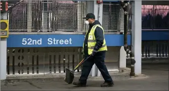  ?? JESSICA GRIFFIN — THE PHILADELPH­IA INQUIRER VIA AP FILE ?? In this March 18, 2020 file photo, SEPTA worker Ervin Lavenhouse wears a mask as he works sweeping up trash on the platform at the 52nd Street station, in Philadelph­ia. The Transport Workers Union that represents nearly 5,000 employees of Philadelph­ia’s regional mass transit authority wants the Southeaste­rn Pennsylvan­ia Transporta­tion Authority to remove a cap on paid leave if workers are exposed to coronaviru­s.