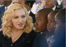  ??  ?? In this July 11 photo, Madonna, left, sits with her adopted children David, Stella and Mercy.