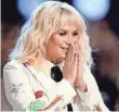  ?? KEVIN WINTER, GETTY IMAGES Kesha ditches the electronic sound to get quirky in her new album, Rainbow, out Friday. ??