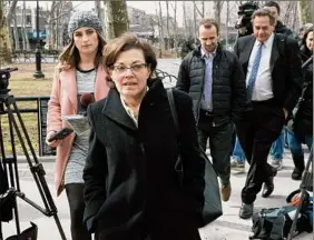  ?? Mary Altaffer / Associated Press archive ?? Nancy Salzman, center, arrives at Brooklyn federal court on March 13, 2019. Salzman, who awaits sentencing on a racketeeri­ng conspiracy charge, has asked for a modificati­on of her bail terms so that she may be with her daughter for the birth of her daughter’s first child.