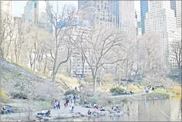  ?? — AFP photo ?? File photo shows people are seen in Central Park on a sunny day in New York City.