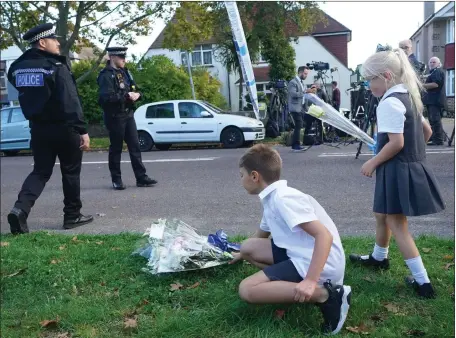  ?? ?? Children leave flowers near Belfairs Methodist Church where Sir David Amess died after he was stabbed several times at a constituen­cy surgery