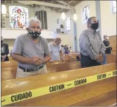  ?? MARCIO JOSE SANCHEZ — THE ASSOCIATED PRESS ?? Faithful pray while yellow tape enforces social distance amid the coronaviru­s pandemic at the San Gabriel Mission on Sunday.