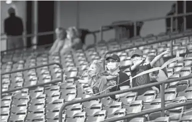  ?? JOE RONDONE/THE COMMERCIAL APPEAL ?? Fans watch as the Memphis 901 FC takes on the Charlotte Independen­ce on Saturday during the first live action at Autozone Park since the season was put on hold to prevent the spread of the coronaviru­s back in March after the team’s first game of the season.