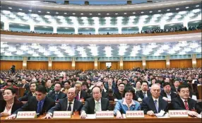  ?? LIU ZHEN ?? NPC deputies cast their votes at the closing of their annual plenary session in the Great Hall of the People on Wednesday.