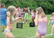  ??  ?? Kennedy Cape (left), 9, chases Nevayah Watters, 9, with a water balloon after Nevayah threw hers at Kennedy Monday during “wet and wild” week at Camp Anthony, the Rome-Floyd Parks &amp; Recreation weekly day camp.