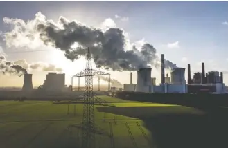  ?? MICHAEL PROBST/ASSOCIATED PRESS ?? A coal-fired power plant near Grevenbroi­ch, Germany. Communitie­s around the world emitted more carbon dioxide than any other year in 2022 as cities turned to coal to provide a cheap source of power.