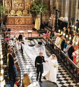  ?? OWEN HUMPHREYS / WPA POOL / GETTY IMAGES ?? Prince Harry and Meghan Markle, now known as the Duke and Duchess of Sussex, walk down the aisle at St. George’s Chapel at Windsor Castle in Windsor, England, following their wedding ceremony Saturday.