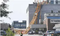  ?? ALISTAIR WATERS/THE CANADIAN PRESS ?? The RCMP, the BC Coroners Service, Worksafebc, firefighte­rs and engineers are all investigat­ing the collapse of a crane in Kelowna that killed at least four people Monday.