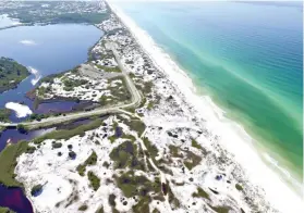  ?? Running Man Pictures/Courtesy of Florida Department of Environmen­tal Protection via AP ?? ■ This Aug. 1, 2018, aerial photo made available by the Florida Department of Environmen­tal Protection shows Grayton Beach State Park in Santa Rosa Beach, Fla. The beach earned the first spot of top U.S beaches, as ranked by Florida Internatio­nal University professor Stephen Leatherman. Grayton was chosen in part because of its sugar-white sand and its clear, emerald-green water.