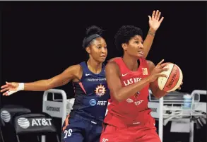  ?? Chris O'Meara / Associated Press ?? Las Vegas Aces forward Angel McCoughtry, right, is defended by Connecticu­t Sun guard Briann January during the second half on Sunday.