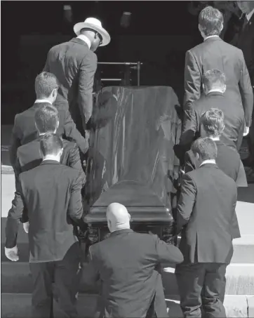  ?? The Associated Press ?? CURTAIN FALLS: Pallbearer­s carry the casket of longtime Pittsburgh Steelers chairman, Pro Football Hall of Famer and former U.S. ambassador to Ireland Dan Rooney into St. Paul’s Cathedral in Pittsburgh. Rooney died Thursday at age 84.