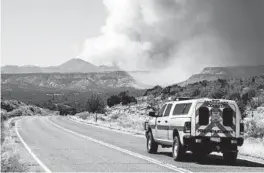  ?? ROBERT BROWMAN/THE ALBUQUERQU­E JOURNAL ?? A Cochiti Fire Department vehicle heads toward smoke from the Cerro Pelado Fire in the Jemez Mountains on Friday in Cochiti, N.M.