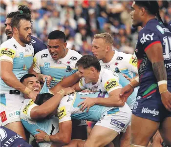  ?? GETTY IMAGES ?? The Titans celebrate a try to David Fifita in their win over the Warriors, their first victory in 2024.