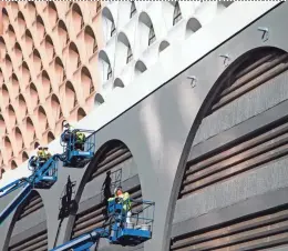  ?? NICK OZA/THE REPUBLIC ?? Painters work on some final touches Wednesday at the Renaissanc­e hotel in downtown Phoenix. November started warm, with a big temperatur­e drop-off near the end.