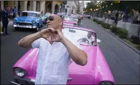  ??  ?? Actor Vin Diesel along Paseo del Prado street in Havana flashes a heart-in-hand to the crowd May 3 ahead of the presentati­on of fashion designer Karl Lagerfeld’s “Cruise” line for fashion house Chanel.