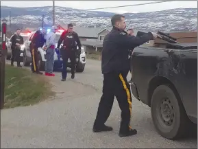  ?? Special to The Daily Courier ?? A police officer checks a rifle he found in a truck after it had been pulled over.