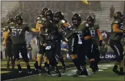  ?? ADAM HUNGER — THE ASSOCIATED PRESS ?? Quarterbac­k Tyhier Tyler, center, and his Army teammates celebrate his fourth-quarter touchdown run against Navy.