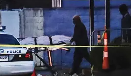  ?? — AP ?? The police removes a body at the Cameo club after a fatal shooting in Cincinnati, Ohio, on Sunday.