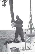  ??  ?? Dr. Deo Florence Onda raises the Philippine flag after the successful descent in the Emden Deep, the third deepest spot on Earth, in the Philippine Deep.