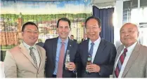  ?? COURTESY OF WILL HSU ?? Will Hsu of Wausau (left) and his father, Hsu’s Ginseng Enterprise founder Paul Hsu (right) share a moment with Gov. Scott Walker and Foxconn CEO Terry Gou during a July 27 announceme­nt in Milwaukee about the agreement between Wisconsin and Foxconn to...