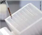  ??  ?? A technician handles a blood sample to test for COVID-19 at a Harwood Heights facility last April.