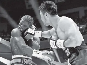  ??  ?? Ryota Murata of Japan (R) punches Hassan N’Dam of France (L) during the World Boxing Associatio­n (WBA) middleweig­ht title bout in Tokyo. - AFP photo