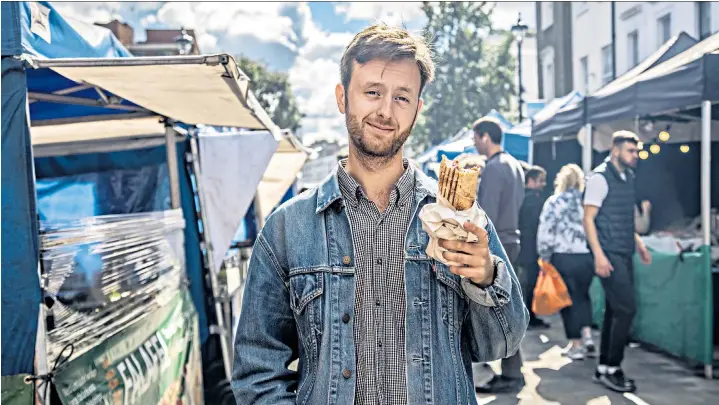  ?? ?? Fast food: Tomé Morrissy-swan with his falafel wrap at Tachbrook Street Market