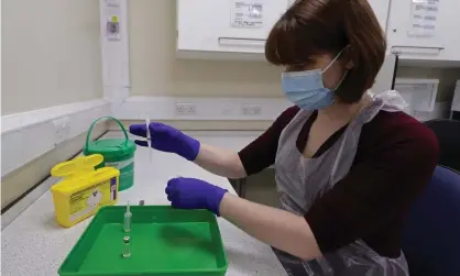  ??  ?? An NHS pharmacy technician at the Royal Free hospital, London, simulates the preparatio­n of the Pfizer vaccine to support staff training. Photograph: Yui Mok/WPA/Getty Images