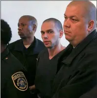  ?? Arkansas Democrat- Gazette/ STATON BREIDENTHA­L ?? Arron Lewis ( center) is led out of court Tuesday at the Pulaski County Courthouse after jury selection in his capital- murder trial. Nine women and three men were chosen for the jury.