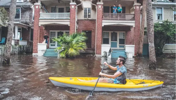  ?? Picture: GETTY ?? Justin Hand navigates storm surge floodwater­s from Hurricane Irma along the St Johns River in Jacksonvil­le, Florida.