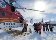  ?? Zhang Jiansong/ Xinhua/the Associated Press ?? Passengers from the trapped Russian vessel MV Akademik Shokalskiy, seen at right, prepare to board the Chinese rescue helicopter Xueying 12 in the Antarctic Thursday.