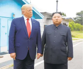  ?? GETTY ?? A photo provided by Dong-A Ilbo shows North Korean leader Kim Jong Un, right, and U.S. President Donald Trump inside the demilitari­zed zone separating South and North Korea on Sunday.