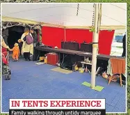  ??  ?? IN TENTS EXPERIENCE Family walking through untidy marquee