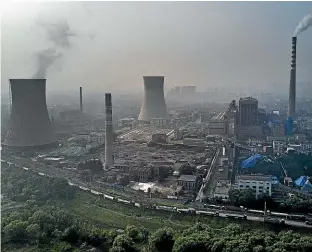  ?? GETTY ?? A Chinese state-owned coal-fired power plant in Huainan, Anhui province, China. We now use proportion­ally more fossil energy than at any time in history, says Mike Joy.