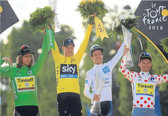  ?? Picture: PA. ?? Tour winner Chris Froome, second left, celebrates on the podium with, from left, points classifica­tion winner Peter Sagan, best young rider Adam Yates and king of the mountains Rafal Majka.